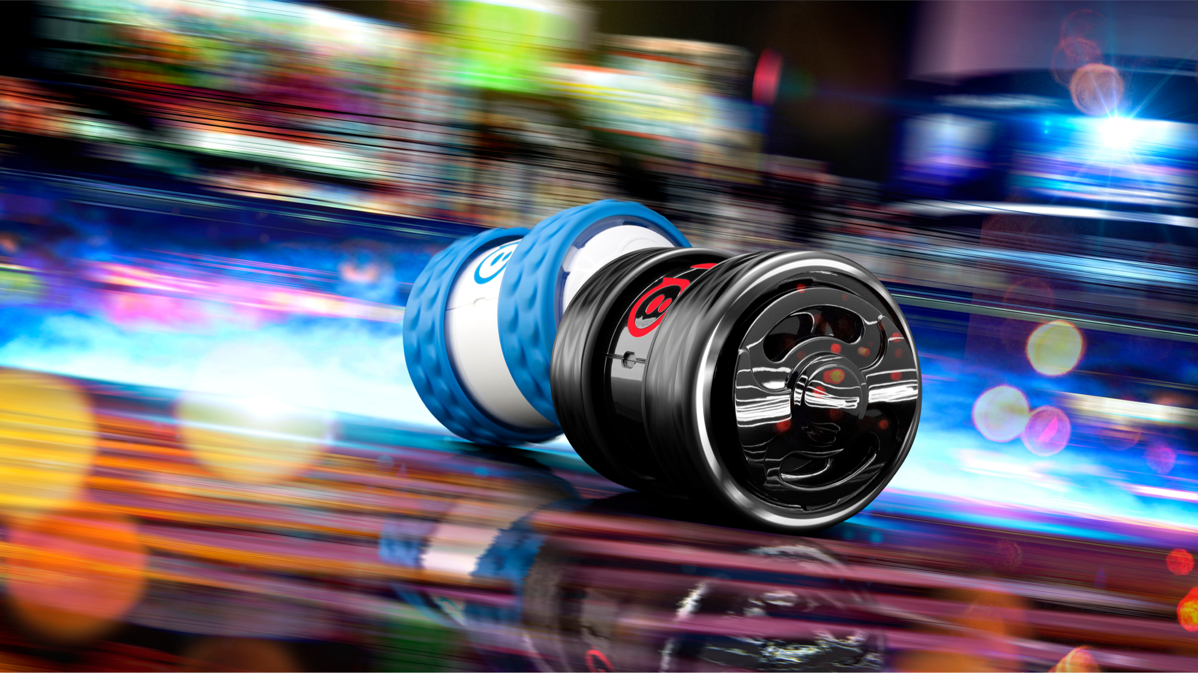 Sphero Ollie robot with a blue tire and black hubcap racing against a blurred, colorful motion-blur background