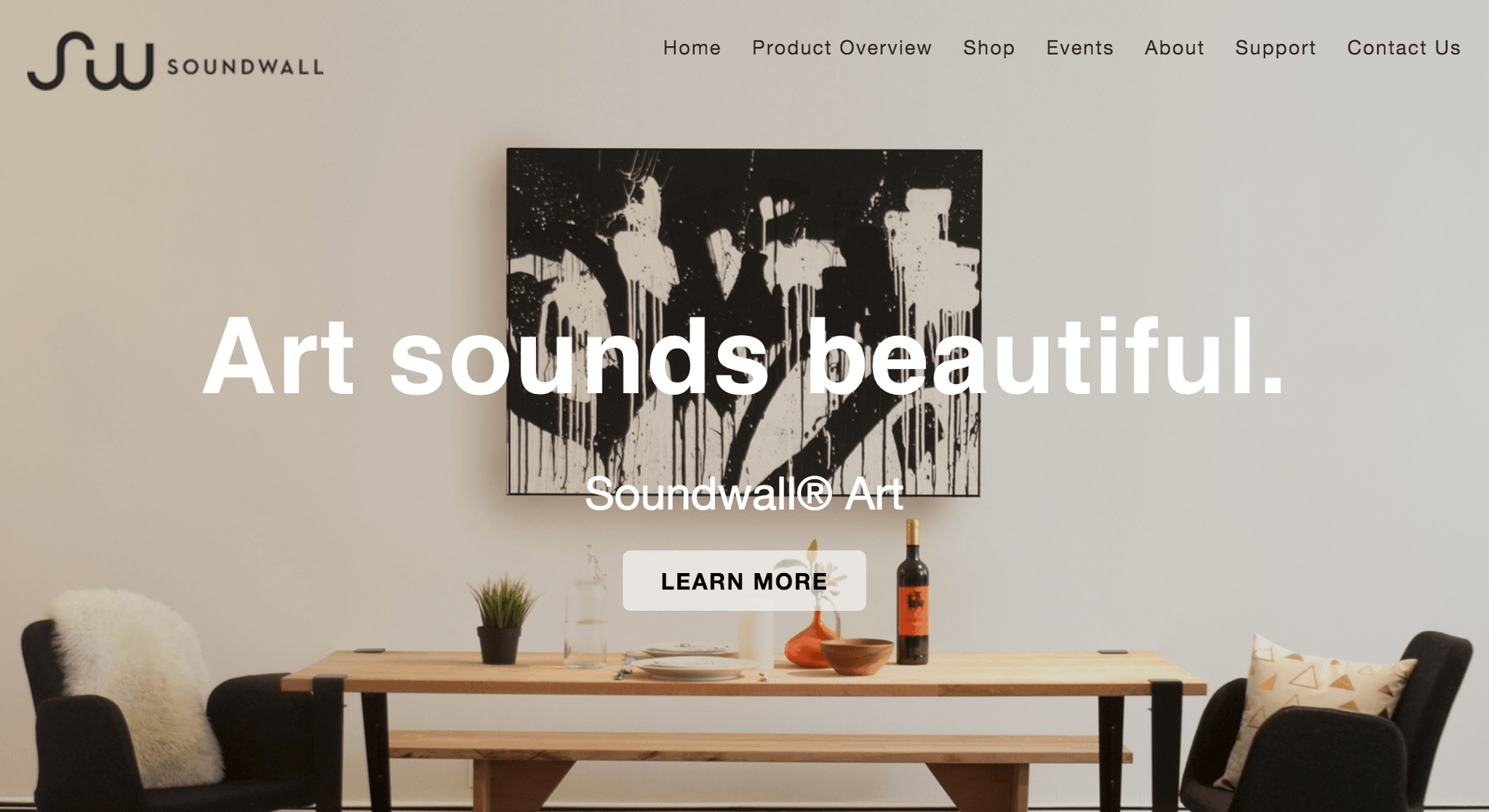 Soundwall website homepage with black-and-white abstract canvas over a dining table, text 'Art sounds beautiful.'