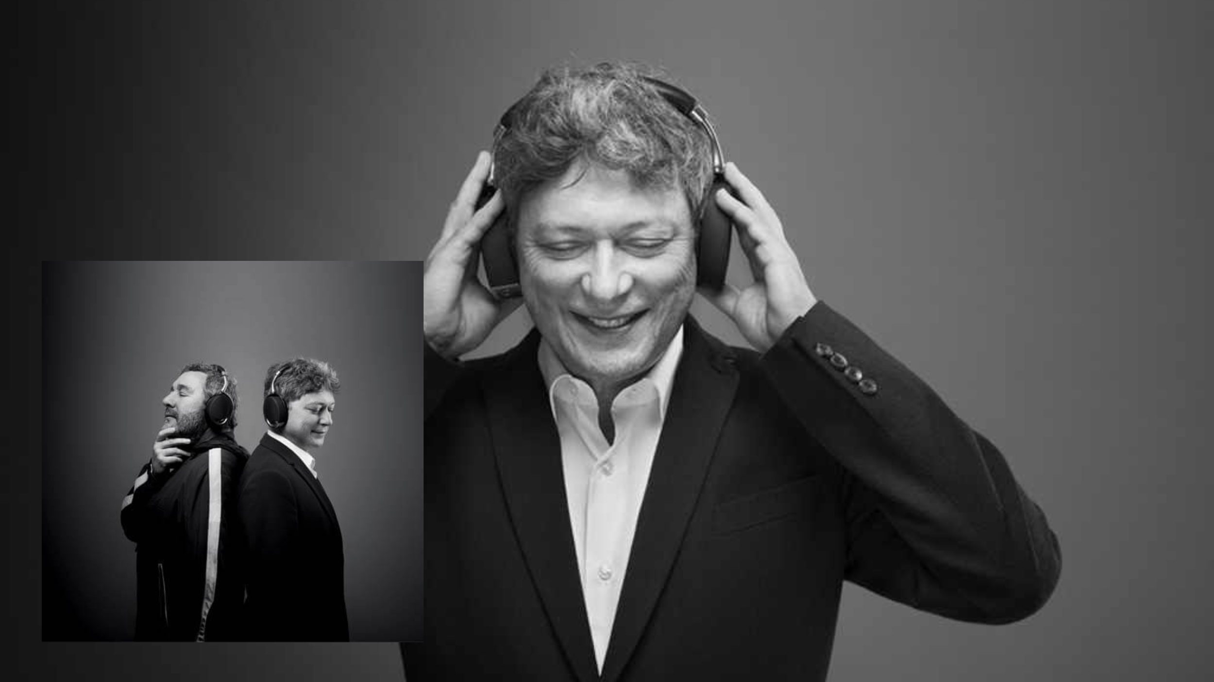 Black-and-white photo of a smiling man in a suit wearing headphones; inset shows two men back to back.