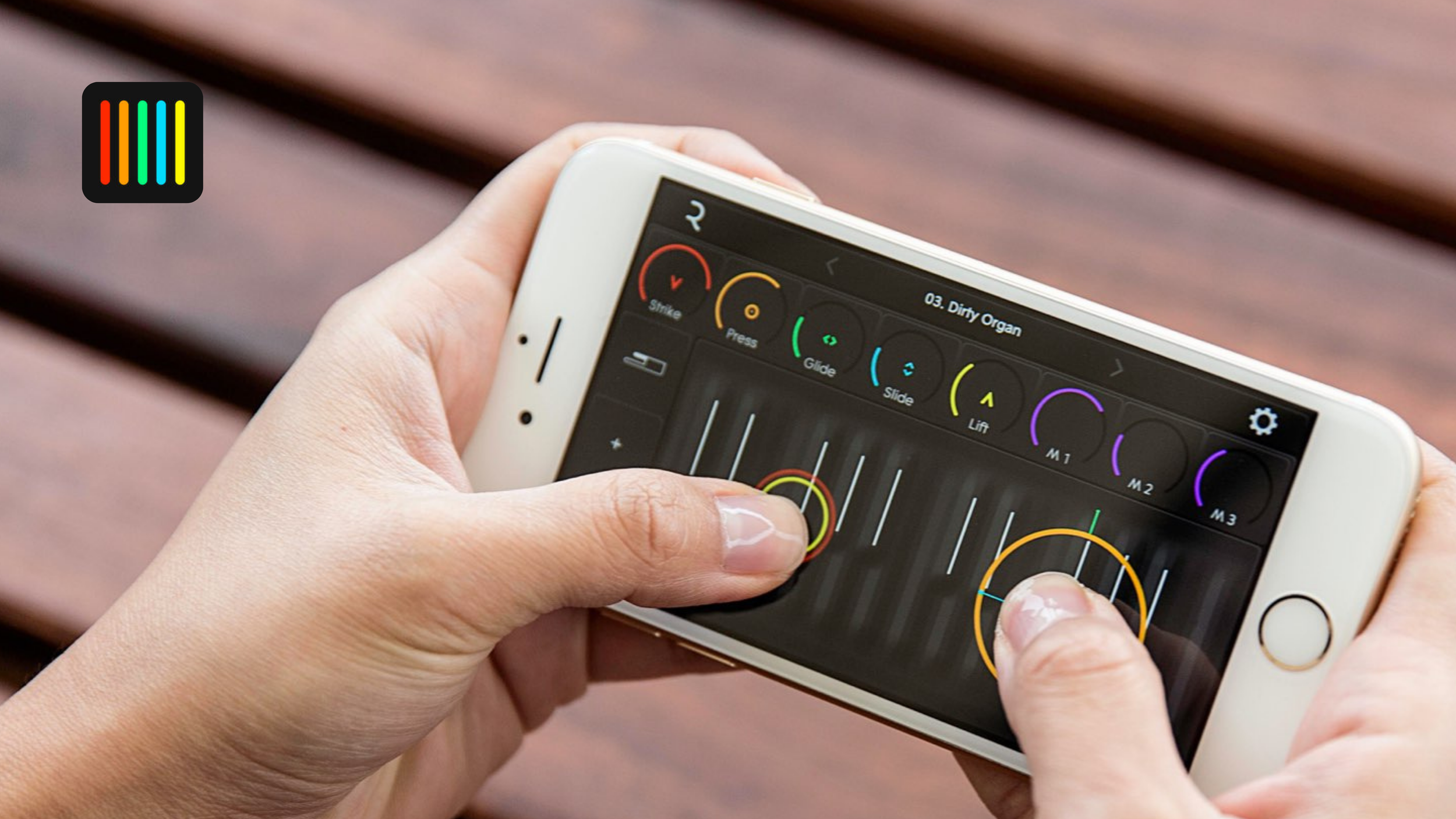 Hands holding a gold iPhone running ROLI's NOISE app on the 'Dirty Organ' preset with colored control dials.
